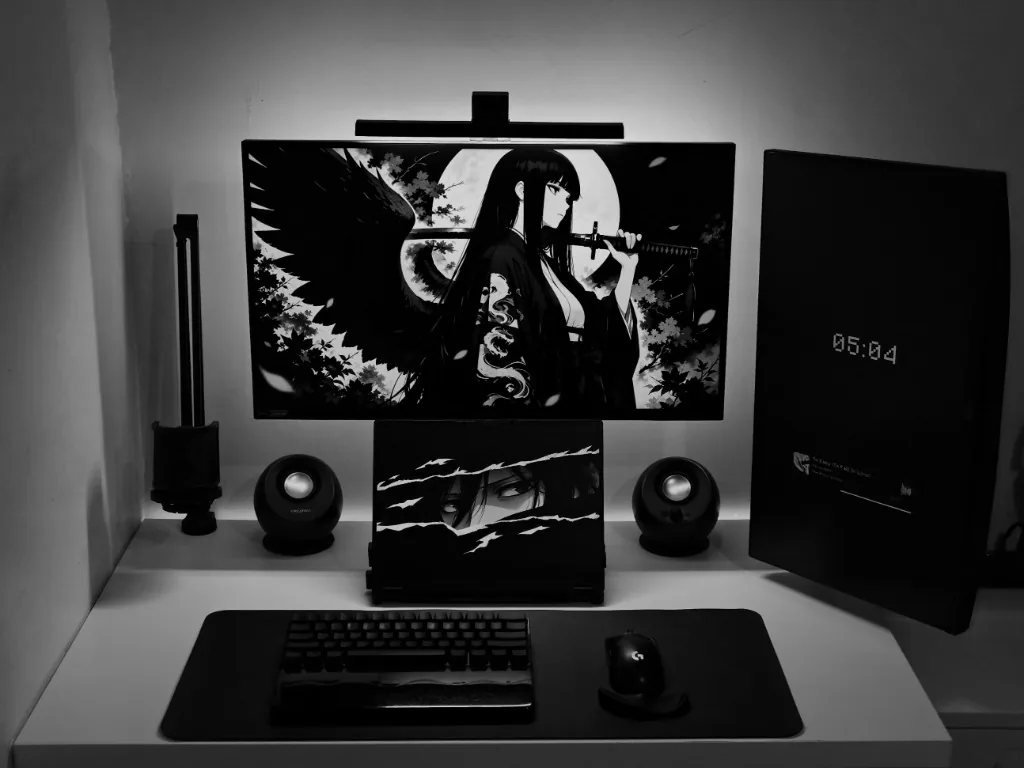 Micko’s monochrome workspace with dual monitors, a laptop, keyboard, and mouse